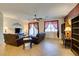 Inviting living room with plush leather seating, a ceiling fan, and stylish curtains that adorn the large windows at 768 Flowing Meadow Dr, Henderson, NV 89014