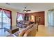 Spacious living room with dual sofas, decorative bookcases, and expansive windows offering views of the outside at 768 Flowing Meadow Dr, Henderson, NV 89014