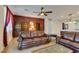 Welcoming living room featuring comfortable leather sofas, built-in shelving, and large windows for plenty of natural light at 768 Flowing Meadow Dr, Henderson, NV 89014