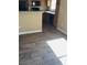 Stylish kitchen with wood-look tile flooring, breakfast bar, and modern black appliances at 833 Aspen Peak Loop # 2511, Henderson, NV 89011