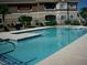 Large, sparkling community swimming pool with lounge chairs and manicured landscaping at 833 Aspen Peak Loop # 2511, Henderson, NV 89011