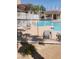 Community pool with sun loungers, partially visible through a white fence, inviting relaxation at 833 Aspen Peak Loop # 2511, Henderson, NV 89011