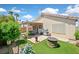 Inviting backyard with a covered patio, outdoor seating, grill, artificial grass, and cozy fire pit at 851 Offerman Ave, Las Vegas, NV 89123