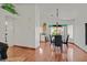 Cozy dining area with hardwood floors, modern lighting, and views to the kitchen and back yard at 851 Offerman Ave, Las Vegas, NV 89123