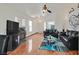 Bright living room featuring a fireplace, ceiling fan, hardwood floors, and comfortable leather sofas at 851 Offerman Ave, Las Vegas, NV 89123