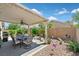 Enjoy this covered patio with an outdoor dining setup, surrounded by a desert landscape at 851 Offerman Ave, Las Vegas, NV 89123