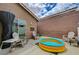 Cozy backyard with an inflatable pool, patio seating, and a private outdoor space at 9431 Borough Park St, Las Vegas, NV 89178