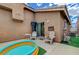 Private backyard patio with comfortable chairs, an inflatable pool, and a sliding glass door at 9431 Borough Park St, Las Vegas, NV 89178