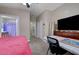 Bedroom with desk, ceiling fan, and bathroom access at 9431 Borough Park St, Las Vegas, NV 89178