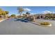 Welcoming community entrance with beautiful signage, lush landscaping, and a well-maintained road at 9431 Borough Park St, Las Vegas, NV 89178