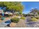 Scenic community park with stone landscaping, lush greenery, and a peaceful walking path at 9431 Borough Park St, Las Vegas, NV 89178