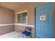 Welcoming covered entry with a window and a charming blue front door with decor at 9431 Borough Park St, Las Vegas, NV 89178