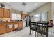 Open-concept kitchen with light wood cabinets, tile flooring, and a dining area at 9431 Borough Park St, Las Vegas, NV 89178
