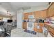 Bright kitchen features tile floors, wood cabinetry, and white appliances at 9431 Borough Park St, Las Vegas, NV 89178