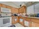 Bright kitchen with light wood cabinets, granite countertops, and essential appliances at 9431 Borough Park St, Las Vegas, NV 89178