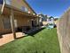 Backyard with a covered patio, artificial turf, and playhouse at , Las Vegas, NV 89129