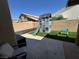 Charming backyard featuring a two-story playhouse with a slide and a picnic table on lush artificial grass at , Las Vegas, NV 89129