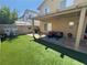 Backyard featuring artificial grass, a covered patio, and seating area at , Las Vegas, NV 89129