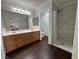 Bathroom features a double sink vanity, walk-in shower, and dark wood-look flooring at , Las Vegas, NV 89129