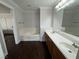 Bathroom features a double sink vanity, bathtub, and dark wood-look flooring at , Las Vegas, NV 89129