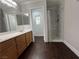 Bathroom features a double sink vanity, walk-in shower, and dark wood-look flooring at , Las Vegas, NV 89129