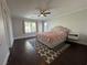 Spacious bedroom with dark floors, ceiling fan, and a large window with bright light at , Las Vegas, NV 89129