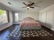 Spacious bedroom with dark floors, ceiling fan, and a large window with bright light at , Las Vegas, NV 89129