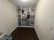 Organized walk-in closet with custom shelving and dark floors at , Las Vegas, NV 89129