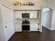 Bright kitchen features stainless steel appliances, white cabinets, and dark floors at , Las Vegas, NV 89129
