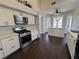 Bright kitchen features stainless steel appliances, white cabinets, and dark floors at , Las Vegas, NV 89129