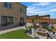 Outdoor patio and artificial turf area with a fire pit and seating at 9641 Rankin Ridge Ct, Las Vegas, NV 89178