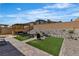Inviting backyard featuring a pergola, fire pit area with chairs, and low-maintenance landscaping at 9641 Rankin Ridge Ct, Las Vegas, NV 89178