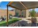 Backyard with wooden patio cover, and seating area with a fire pit at 9641 Rankin Ridge Ct, Las Vegas, NV 89178