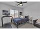 Inviting bedroom with a treadmill, bed, and window providing natural light at 9641 Rankin Ridge Ct, Las Vegas, NV 89178