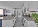 Bright kitchen featuring stainless steel appliances, a large island, and stylish white cabinetry at 9641 Rankin Ridge Ct, Las Vegas, NV 89178