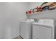 Functional laundry room equipped with a washer and dryer and shelving at 9641 Rankin Ridge Ct, Las Vegas, NV 89178