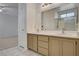 Bathroom with double vanity, tile floor, and a walk-in shower at 1012 Vanier Ct, Henderson, NV 89052