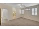 Bedroom with carpet, ceiling fan, windows, and walk-in closet at 1012 Vanier Ct, Henderson, NV 89052