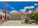 Charming single-story home featuring a two-car garage, desert landscaping, and a classic Spanish tile roof at 1012 Vanier Ct, Henderson, NV 89052