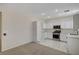 Bright kitchen features white cabinets, stainless steel appliances, and tiled floors at 1012 Vanier Ct, Henderson, NV 89052