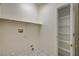 Bright laundry room featuring a storage shelf and a closet with shelving at 1012 Vanier Ct, Henderson, NV 89052