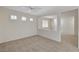Bright and inviting room with neutral carpeting, showcasing an open layout and abundant natural light through shuttered windows at 1012 Vanier Ct, Henderson, NV 89052