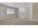 Light-filled living room with neutral carpeting, a bright window with shutters, and a welcoming entrance at 1012 Vanier Ct, Henderson, NV 89052