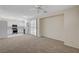Open-concept living space with updated carpet, seamlessly connecting the living room, kitchen, and dining areas at 1012 Vanier Ct, Henderson, NV 89052