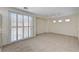 Bright living room with big sliding glass doors and neutral carpet at 1012 Vanier Ct, Henderson, NV 89052