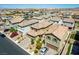 An aerial view showcases the property with a two-car garage and desert landscaping in a quiet neighborhood at 10352 Rye Patch Creek St, Las Vegas, NV 89141