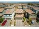 An aerial view showcases the property with a two-car garage and desert landscaping in a quiet neighborhood at 10352 Rye Patch Creek St, Las Vegas, NV 89141