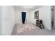 Neutral-toned bedroom with a large carpet, modern lighting and simple decor at 10352 Rye Patch Creek St, Las Vegas, NV 89141