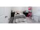 Bedroom featuring a twin bed, dresser, black desk, and pink shelf at 10352 Rye Patch Creek St, Las Vegas, NV 89141