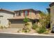 Charming two-story home featuring a two-car garage and desert landscaping in a quiet neighborhood at 10352 Rye Patch Creek St, Las Vegas, NV 89141
